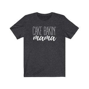 May include: Dark heather grey t-shirt with the text "Cake Bakin' mama" in white.