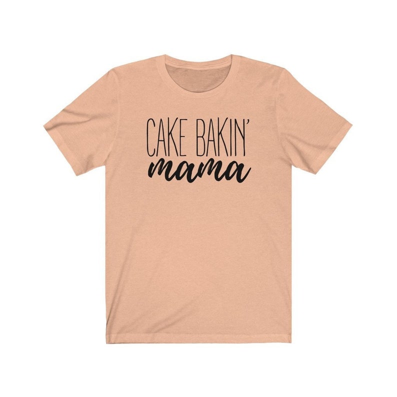 May include: A peach-colored t-shirt with the text "CAKE BAKIN' mama" printed in black.