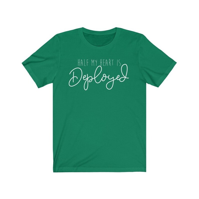 May include: A green t-shirt with the text "Half my heart is Deployed" in white.