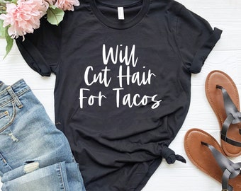 May include: Black t-shirt with white text that reads "Will Cut Hair For Tacos".