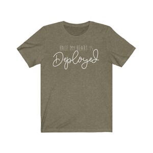 May include: A green t-shirt with the text "Half my heart is Deployed" in white.