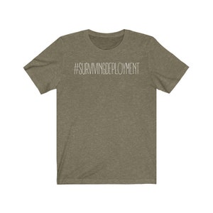 May include: A green t-shirt with the text "#SURVIVINGDEPLOYMENT" printed in white on the front.