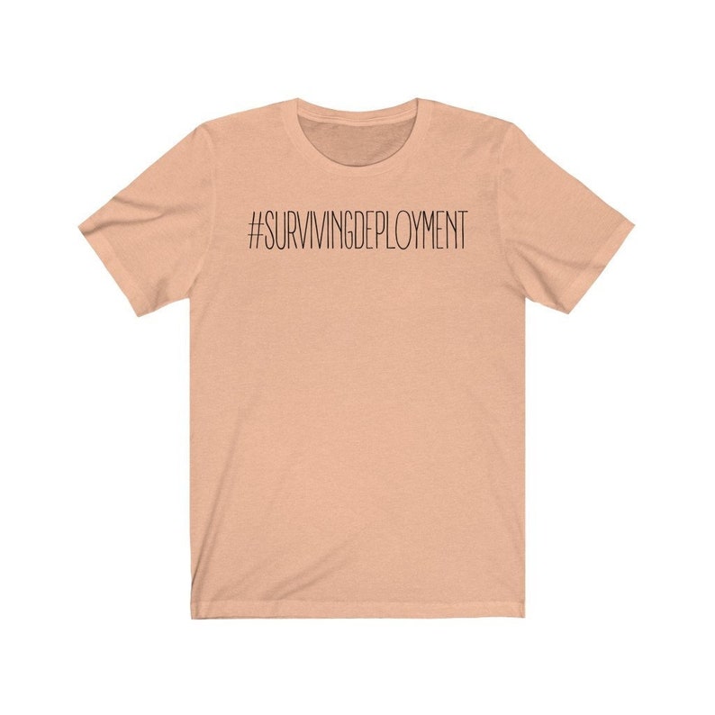 May include: A peach-colored t-shirt with the text "#SURVIVINGDEPLOYMENT" printed in black.