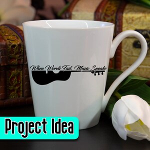 May include: White ceramic coffee mug with a black silhouette of a guitar and the text "When Words Fail, Music Speaks".