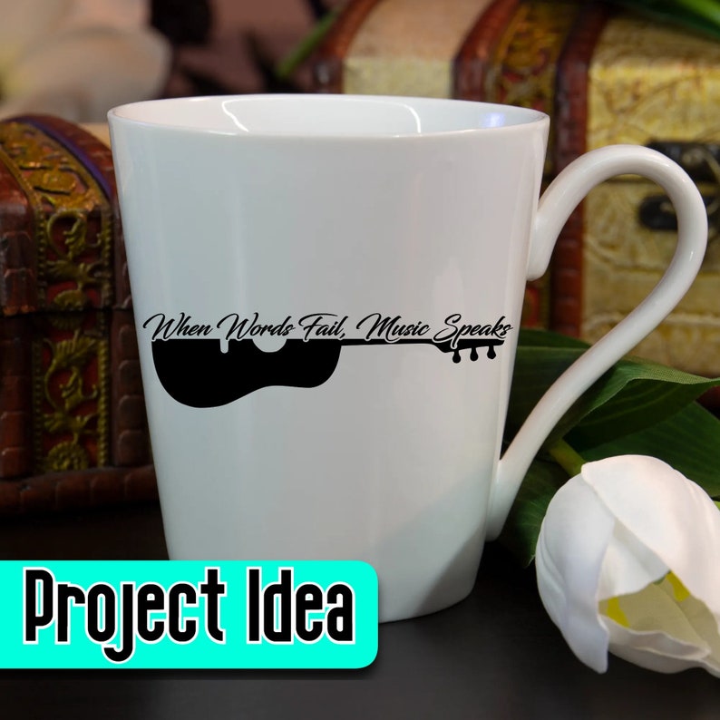May include: White ceramic coffee mug with a black silhouette of a guitar and the text "When Words Fail, Music Speaks".