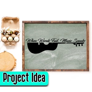 May include: A framed chalkboard with a black silhouette of a guitar and the text "When Words Fail, Music Speaks".