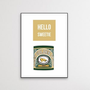 May include: A white framed print with the text "HELLO SWEETIE" in a yellow box. Below the text is a green and gold can of Lyle's Golden Syrup with the text "LYLE'S GOLDEN SYRUP" printed on the can.
