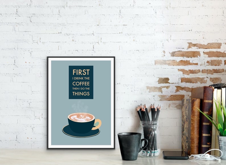 May include: A blue and white poster with the text "FIRST I DRINK THE COFFEE THEN I DO THE THINGS" and a stylized illustration of a cup of coffee with steam rising from it.