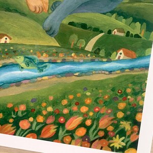 May include: A painting depicting a landscape with a blue river flowing through green hills, small houses, and a field of orange, yellow, and red flowers. A green fish leaps from the water, while a blue creature's paw reaches down from above.