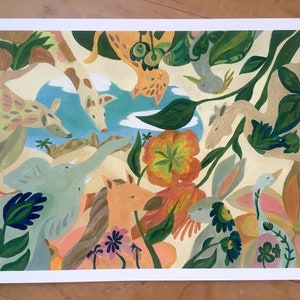 May include: A rectangular art print featuring a painted scene of various animals including a light blue elephant, a tan horse, a rabbit, and a giraffe amidst lush green foliage, large orange flowers, and a small blue pond under a pale yellow sky.