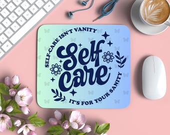 May include: A blue and white gradient mouse pad with the text "Self-care isn't vanity, it's for your sanity" in a dark blue font. The text is surrounded by flowers and butterflies.