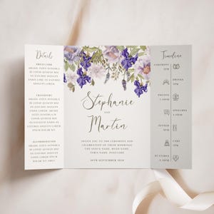 May include: A wedding invitation with a floral design featuring purple and white flowers. The invitation includes the names Stephanie and Martin, the date September 20th, 2010, and a timeline of events.