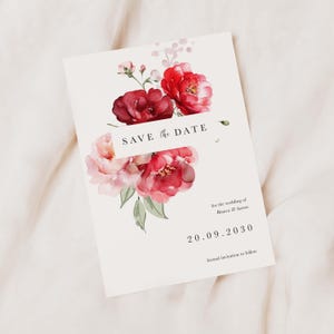 May include: Save the Date wedding invitation with a watercolour floral design featuring pink and red flowers. The text reads "Save the Date" for the wedding of Bianca & Aaron, 20.09.2030, formal invitation to follow.
