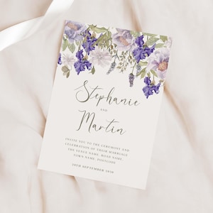 May include: Wedding invitation with a floral design featuring purple and white flowers. The invitation reads "Stephanie and Martin" and includes the date "20th September 2030".