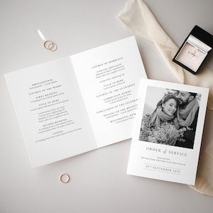 May include: Black and white wedding ceremony order of service with a photo of the couple in the background. The text reads "Order of Service" and "20th September 2030".