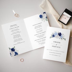 May include: A wedding ceremony order of service with blue and white floral designs. The text reads "Order of Service" and "Joy Adams & Nicholas Turner" with the date "20th September 2020".