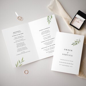 May include: A white wedding ceremony order of service booklet with green foliage illustrations. The text reads "Order of Service" and "Charlotte & Noah" with the date "20th September 2018".
