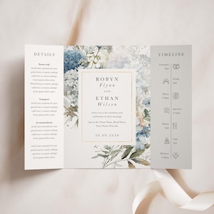 Op de afbeelding: Een huwelijksuitnodiging met een aquarelbloemendesign in tinten blauw en wit. De uitnodiging bevat de namen "Robyn Flynn" en "Ethan Wilson" en de datum "20.09.2030". De uitnodiging bevat ook een tijdlijn van de gebeurtenissen voor de huwelijksdag.
