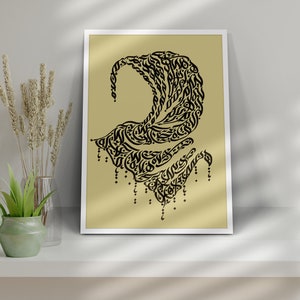 May include: A framed print with a black and white calligraphic design on a light yellow background. The design is a flowing, abstract shape with intricate details.