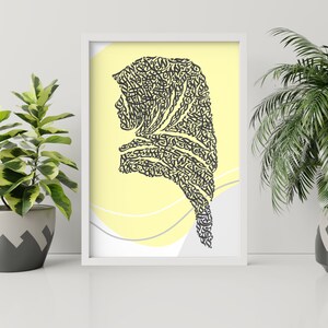 May include: A framed print with a yellow background and a black silhouette of a woman's head and shoulders. The silhouette is made up of intricate calligraphy.