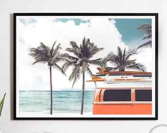May include: A vintage orange van with surfboards strapped to the roof, parked on a beach with palm trees and a blue ocean in the background.