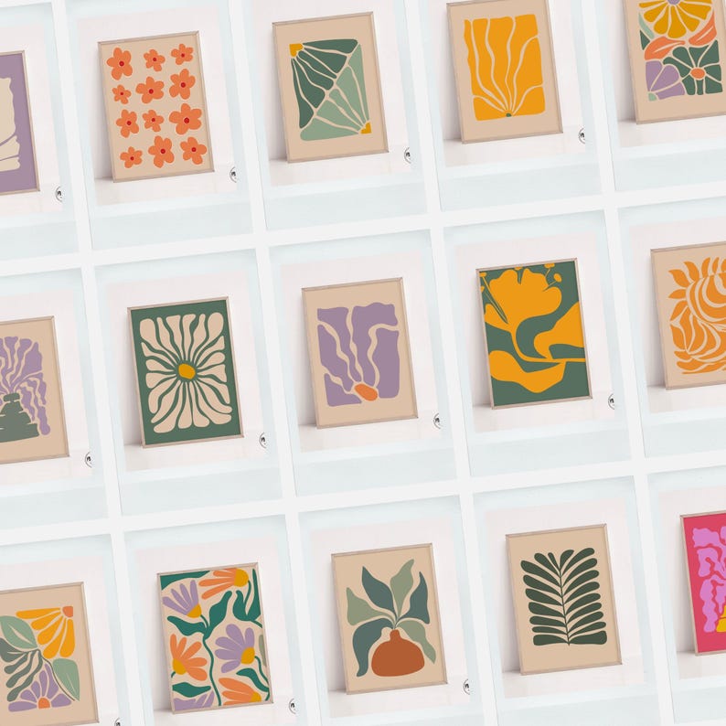 May include: A collection of framed art prints featuring abstract floral and botanical designs. The prints showcase various color palettes, including orange, green, purple, and yellow, with a neutral background. The art style is modern and minimalist.