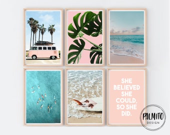 May include: Set of six pink and blue framed prints with beach and ocean themes. One print features a pink vintage van with palm trees in the background. Another print features a large green tropical leaf on a pink background. One print features a quote: "She believed she could, so she did."  The remaining prints feature various ocean scenes.