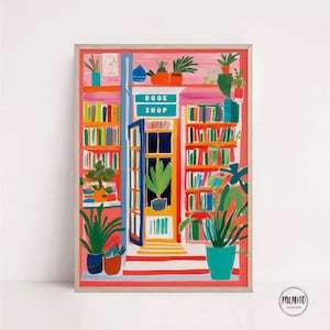 May include: A framed art print depicting a vibrant bookstore interior. The artwork shows bookshelves, potted plants, and the words "BOOK SHOP" above the entrance. The colour scheme includes red, orange, green, and blue hues.