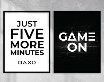 May include: Two black framed prints with white text. The left print says "Just Five More Minutes" with a square, triangle, X, and circle symbol below. The right print says "Game On" on a black brick background.