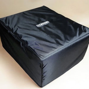 May include: A black, square cover with a white "CUSTOM" logo. The cover is made of a shiny, water-resistant material and has a stitched seam around the edges. The cover is designed to fit over a square object.