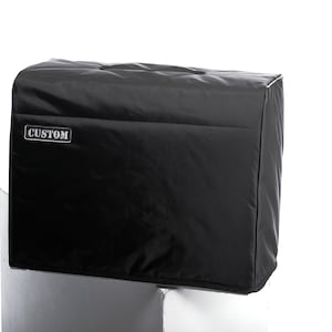 May include: Black amp cover with a zipper and a handle. The cover has the word "CUSTOM" printed on the front.