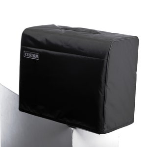May include: Black amp cover with the word "CUSTOM" printed on the front.