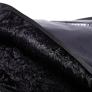 May include: Black fabric bag with a soft, plush lining. The bag is made of a durable material and has a zipper closure.