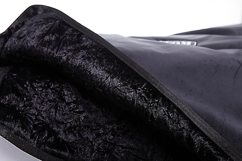 May include: Black fabric bag with a soft, plush lining. The bag is made of a durable material and has a zipper closure.