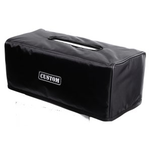 May include: Black amp head cover with a white "CUSTOM" label.