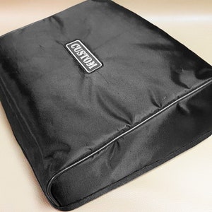 May include: Black custom-made carrying case with a zipper closure and a white label that says "CUSTOM".