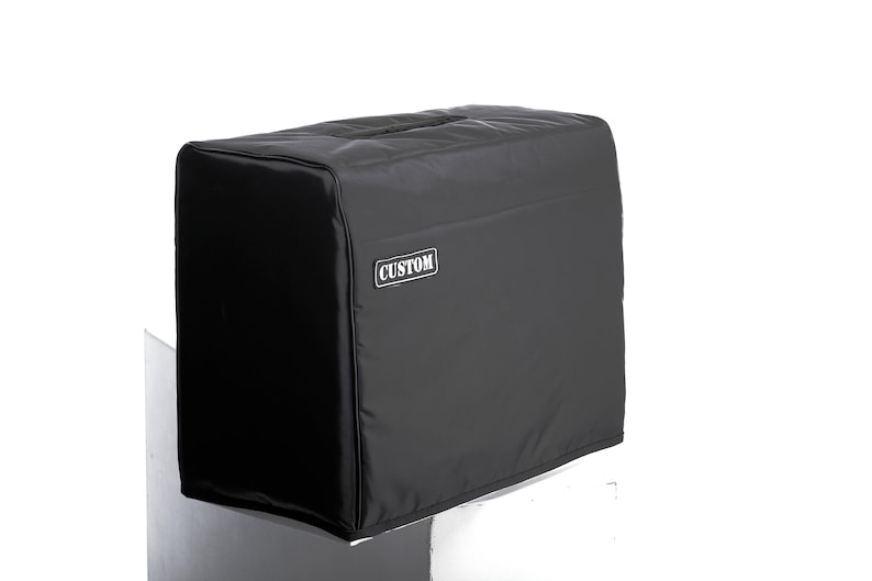 May include: Black amp cover with the word "CUSTOM" printed on the front.