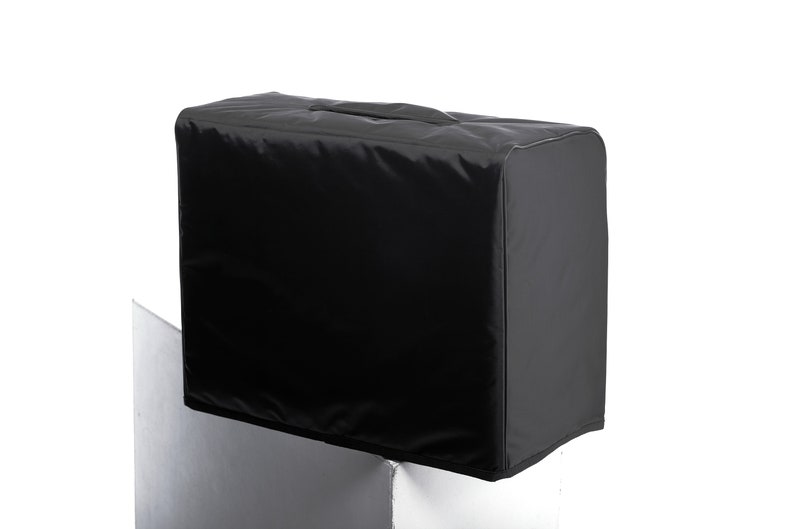 May include: Black amp cover with a carrying handle.