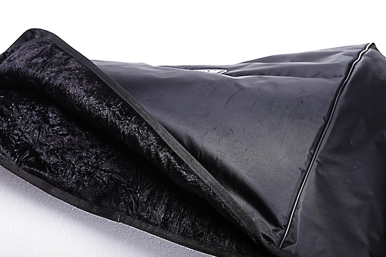 May include: Black padded case with a zipper closure and a soft black lining. The case is made of a durable material and is designed to protect your equipment.