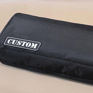 May include: Black custom carrying case with a white "CUSTOM" label.