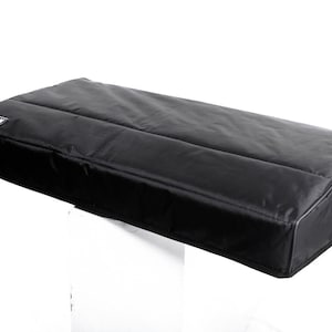 May include: Black keyboard cover with the word "CUSTOM" printed on it.