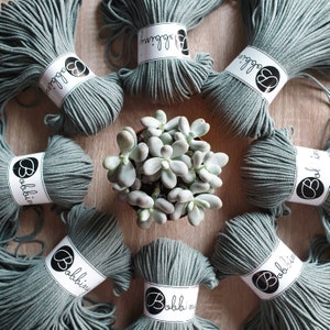 May include: Eight spools of sage green cotton rope with the brand name "Bobbin" printed on each spool.