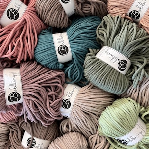 May include: A variety of colors of cotton rope, each wound into a ball. The rope is labeled with the brand name "Bobbiny".