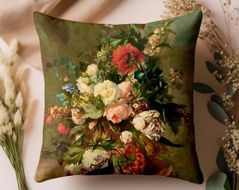 May include: Square throw pillow featuring a vintage floral still life painting. The pillow displays a bouquet of roses, peonies, and other flowers in shades of red, pink, white, and yellow against a dark green background. The pillow is a decorative home accent.