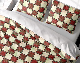 May include: A white duvet cover with a red and green checkered pattern. The duvet cover is on a bed with two matching pillowcases.