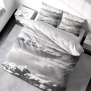 May include: A gray and white duvet cover with a cloud pattern. The duvet cover is made of soft, breathable fabric and is perfect for any bedroom.
