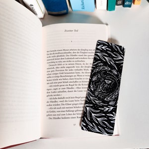 May include: Black and white bookmark with a floral design and the text "Moonchild".