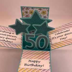 May include: A handmade pop-up birthday card with teal glitter stars and the number 50. The card has text that reads "Wishing a Special person A very special Birthday!", "Celebrate! It's your special Day!", and "Happy Birthday!"