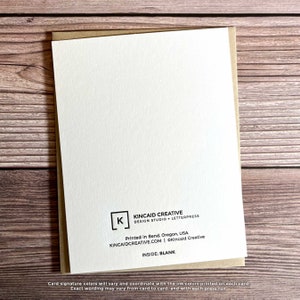 May include: The back of a blank greeting card with a brown envelope. The card has a white background with black text that reads "Kincaid Creative Design Studio + Letterpress" and "Printed in Bend, Oregon, USA Kincaidcreative.com | &copy;Kincaid Creative Inside: Blank".