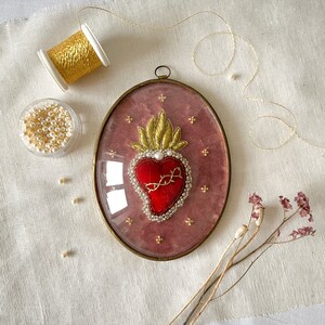 Ex-voto embroidery in its gilded frame